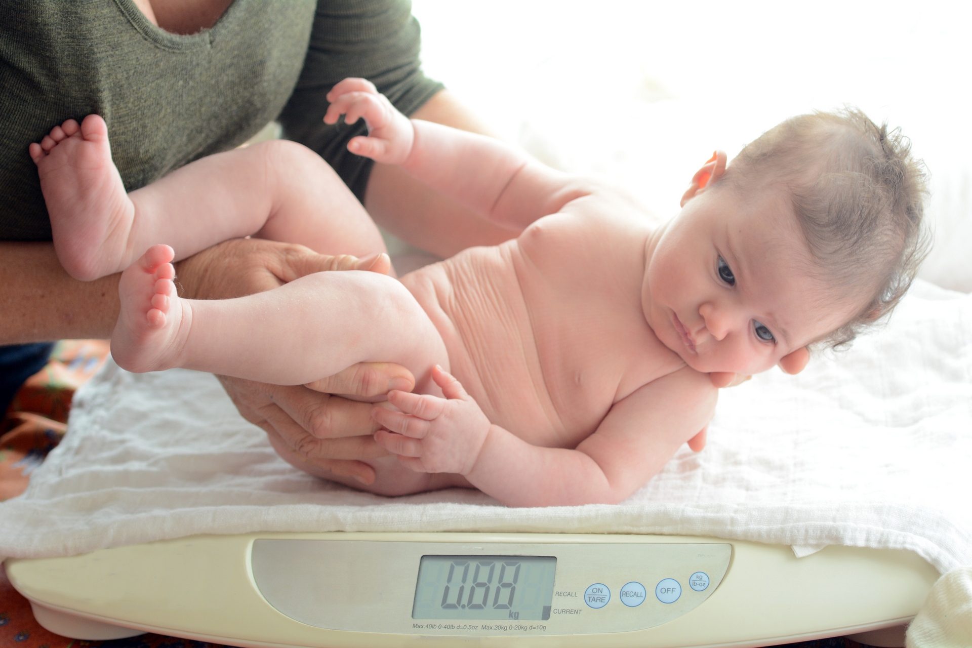 Three months old infant baby been examined on the balance