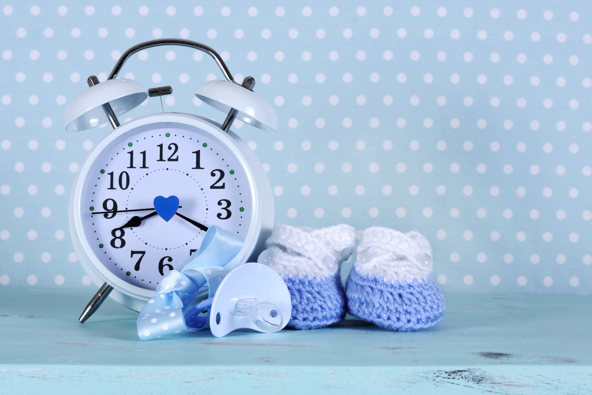 Baby boy nursery blue and white booties and clock, on aqua vinta