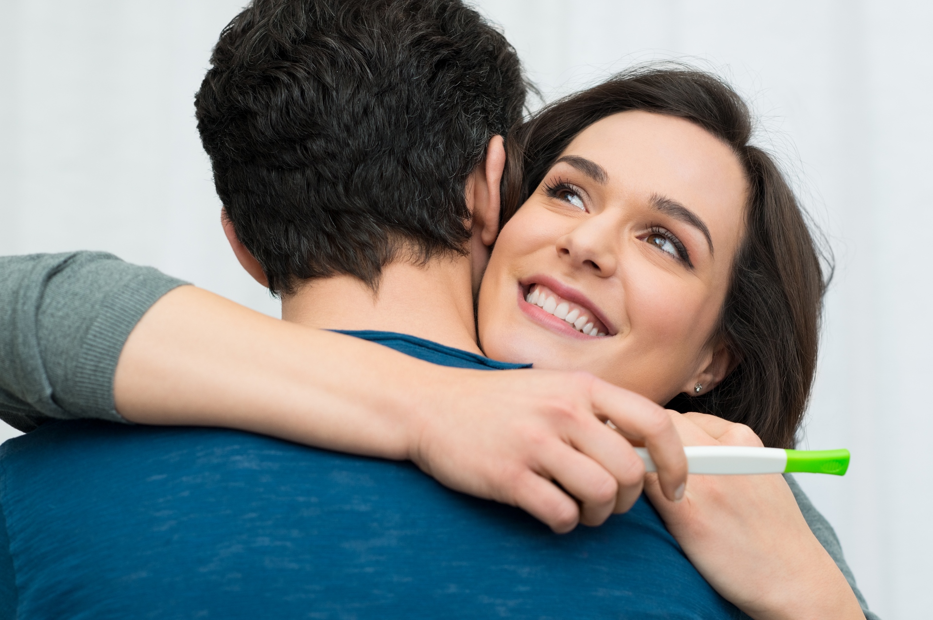 Happy couple with a pregnancy test